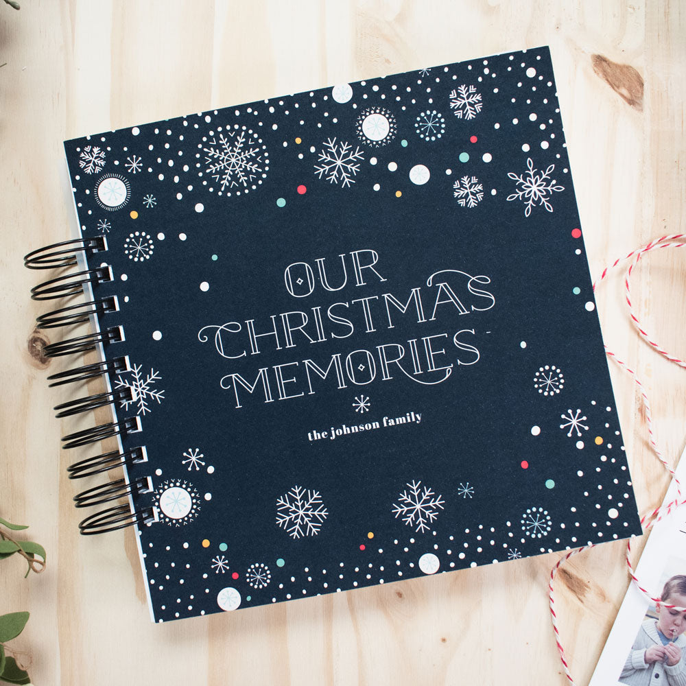 Our Christmas Memories Book journal scrapbook with personalized cover sitting on a table, the perfect christmas gift for friends and family