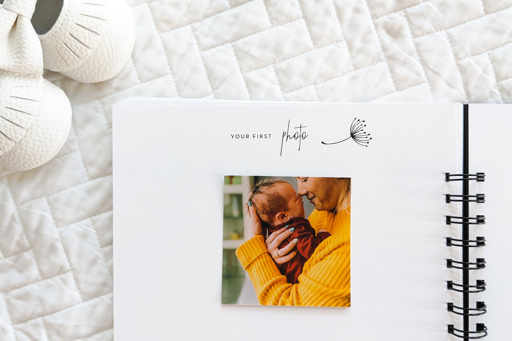 Your first photo page with photo of mom and baby inside of pregnancy journal book to track pregnancy week by week with pictures of baby and belly and journaling space sitting on white quilt 